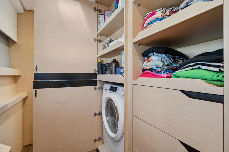 Navitas Yacht Photos Pics Laundry area with washing machine and shelves in 2019 Itacatamarans 14.99 model.