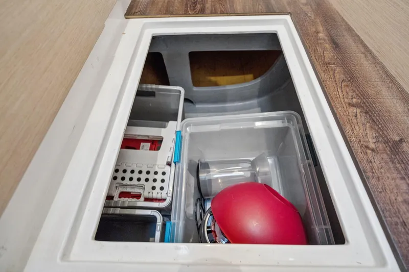 Navitas Yacht Photos Pics Storage compartment on 2019 Itacatamarans 14.99, featuring organized containers and equipment.