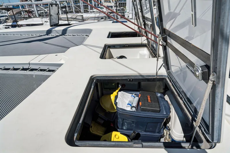 Navitas Yacht Photos Pics Open storage compartments on 2019 Itacatamarans 14.99 deck, containing tools and equipment.