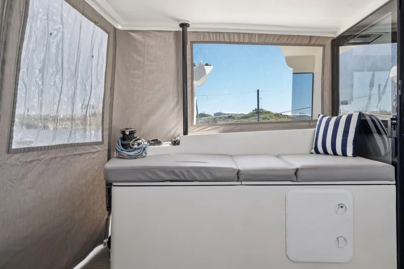 Navitas Yacht Photos Pics 2019 Itacatamarans 14.99 interior with cushioned seating and striped pillow.