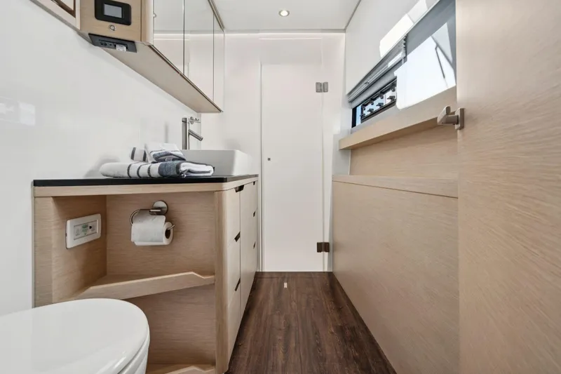 Navitas Yacht Photos Pics Luxurious bathroom interior of 2019 Itacatamarans 14.99, featuring modern fixtures and wood accents.