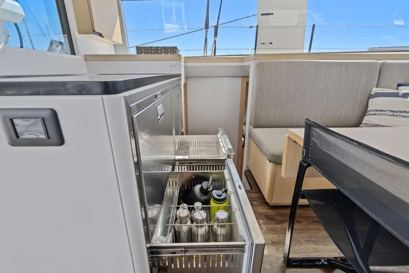 Navitas Yacht Photos Pics Interior of 2019 Itacatamarans 14.99, featuring a modern kitchen with open drawer fridge.