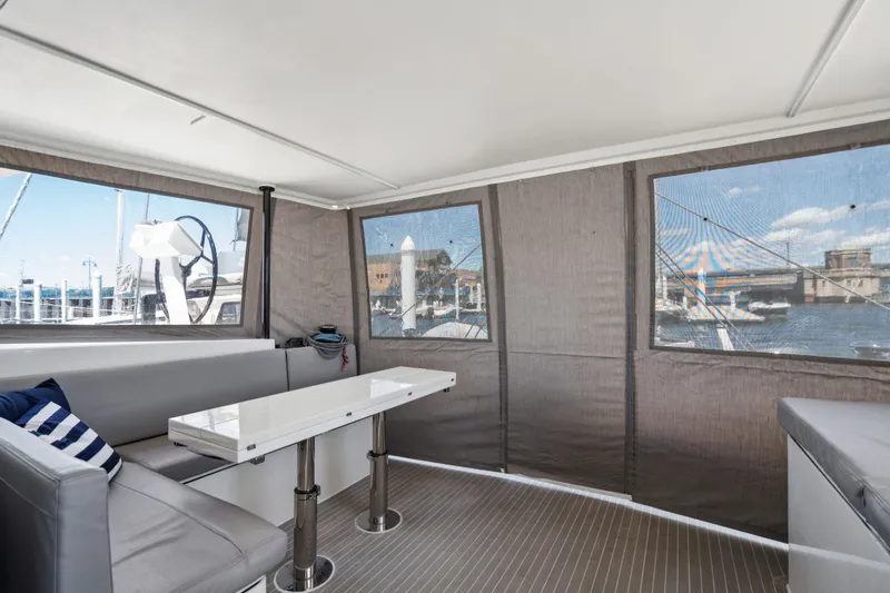 Navitas Yacht Photos Pics Interior of 2019 Itacatamarans 14.99 with modern seating and marina view.