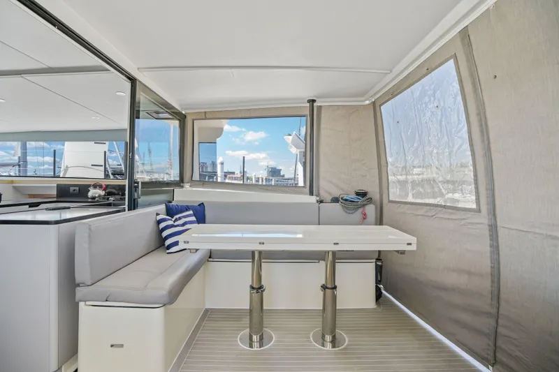Navitas Yacht Photos Pics 2019 Itacatamarans 14.99 interior with seating area, table, and window view.