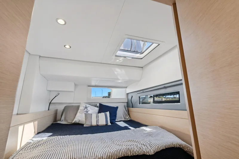 Navitas Yacht Photos Pics Luxurious cabin interior of 2019 Itacatamarans 14.99 with skylight and modern bedding.