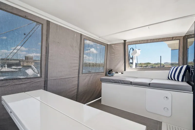 Navitas Yacht Photos Pics 2019 Itacatamarans 14.99 interior with seating, table, and panoramic windows.