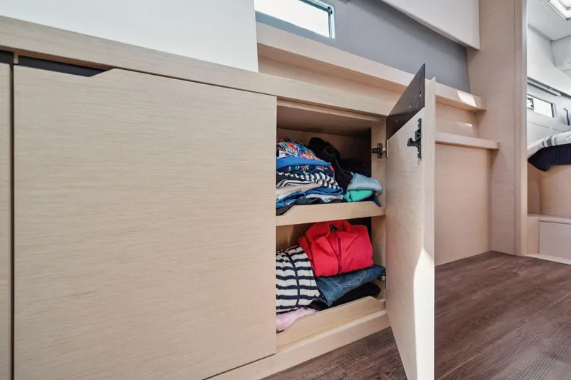 Navitas Yacht Photos Pics Open cabinet with folded clothes inside Itacatamarans 14.99, 2019 model interior.