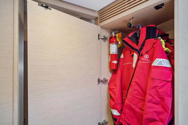 Navitas Yacht Photos Pics Open closet on Itacatamarans 14.99, featuring red jackets and a fire extinguisher, 2019 model.
