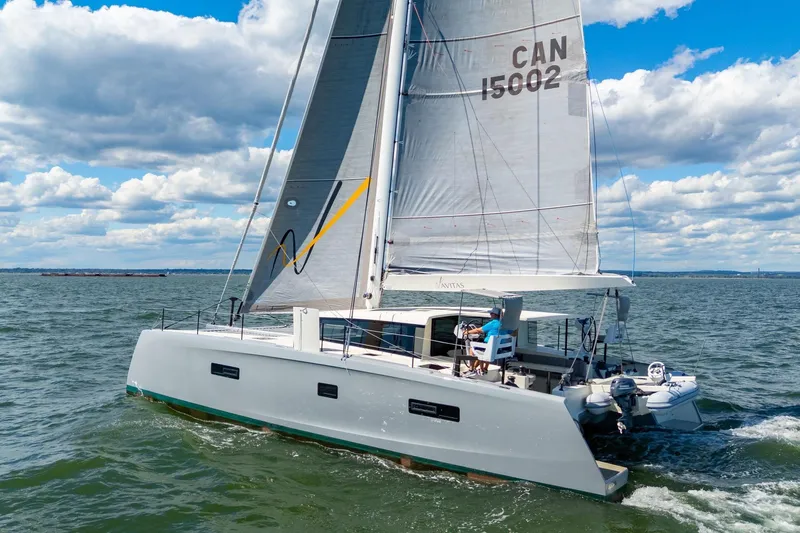 Navitas Yacht Photos Pics 2019 Itacatamarans 14.99 sailing on open water under a cloudy sky.
