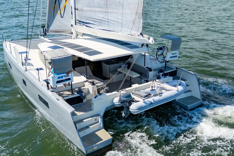 Navitas Yacht Photos Pics 2019 Itacatamarans 14.99 sailing catamaran with solar panels and dinghy on open water.