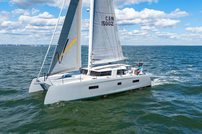 Navitas Yacht Photos Pics 2019 Itacatamarans 14.99 sailing on open water under a clear blue sky.