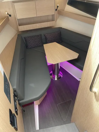 Inventory Clearance Yacht Photos Pics Modern interior of 2023 Bavaria Vida 33 yacht with cozy seating and ambient lighting.