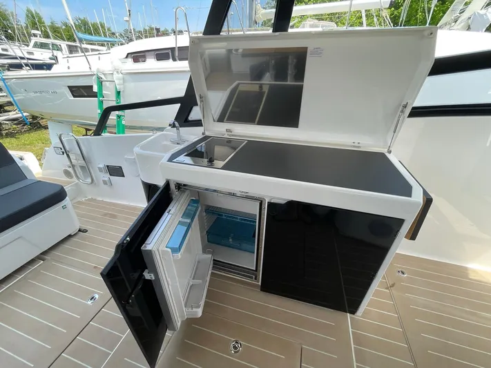 Inventory Clearance Yacht Photos Pics Outdoor kitchen on 2023 Bavaria Vida 33 yacht with open fridge and storage.