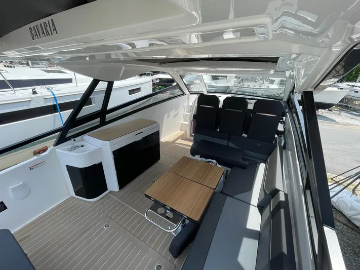 Inventory Clearance Yacht Photos Pics 2023 Bavaria Vida 33 boat interior with seating, table, and kitchenette.