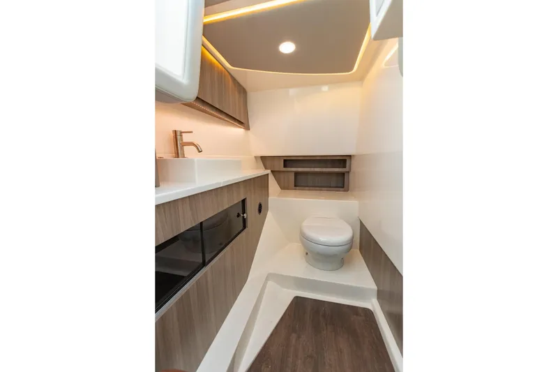The Big Dill Yacht Photos Pics 2023 Regal LS36 boat interior bathroom with modern fixtures and wood accents.