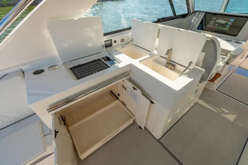 The Big Dill Yacht Photos Pics 2023 Regal LS36 yacht interior with kitchenette, featuring sink and storage compartments.