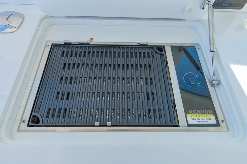 The Big Dill Yacht Photos Pics Built-in Kenyon grill on 2023 Regal LS36 boat, featuring sleek design and control panel.