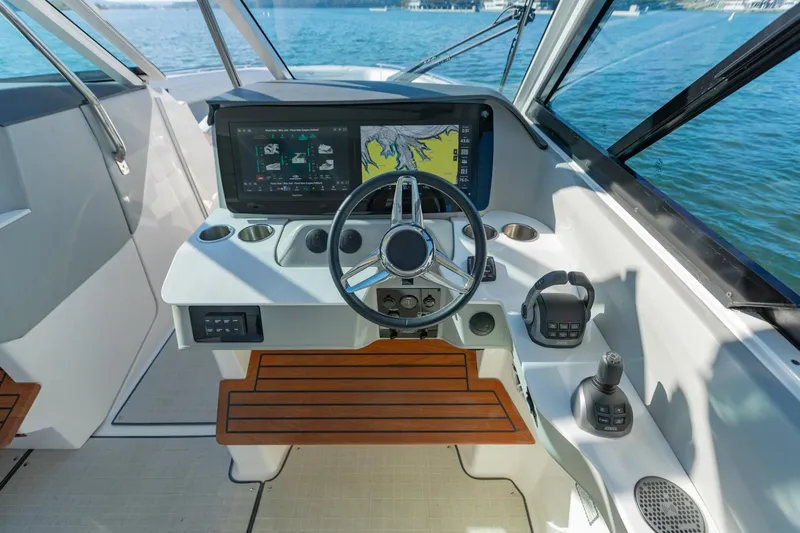 The Big Dill Yacht Photos Pics 2023 Regal LS36 boat helm with modern controls and navigation display on open water.