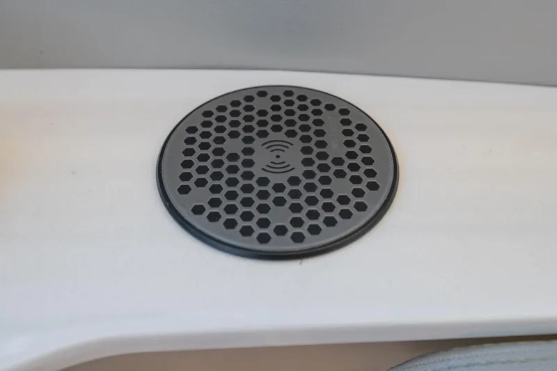 The Big Dill Yacht Photos Pics 2023 Regal LS36 wireless charging pad with hexagonal design on a white surface.