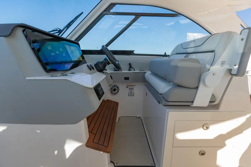 The Big Dill Yacht Photos Pics 2023 Regal LS36 boat interior with modern dashboard and comfortable seating.