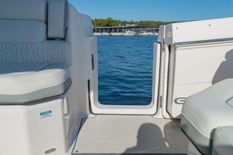 The Big Dill Yacht Photos Pics 2023 Regal LS36 boat interior with open door, overlooking serene blue water.