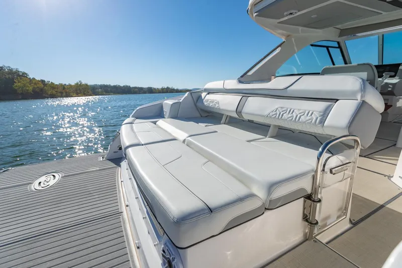 The Big Dill Yacht Photos Pics 2023 Regal LS36 luxury boat with spacious seating on a sunny lake.