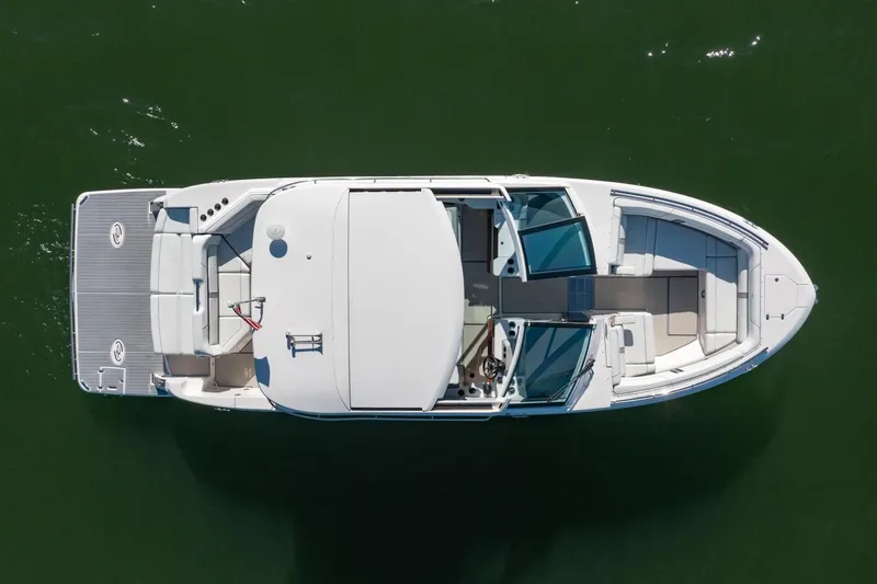 The Big Dill Yacht Photos Pics Top view of 2023 Regal LS36 boat on calm green water.