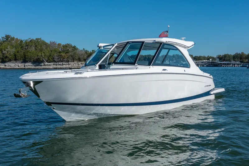 The Big Dill Yacht Photos Pics 2023 Regal LS36 boat cruising on a sunny day, with clear blue skies and calm waters.