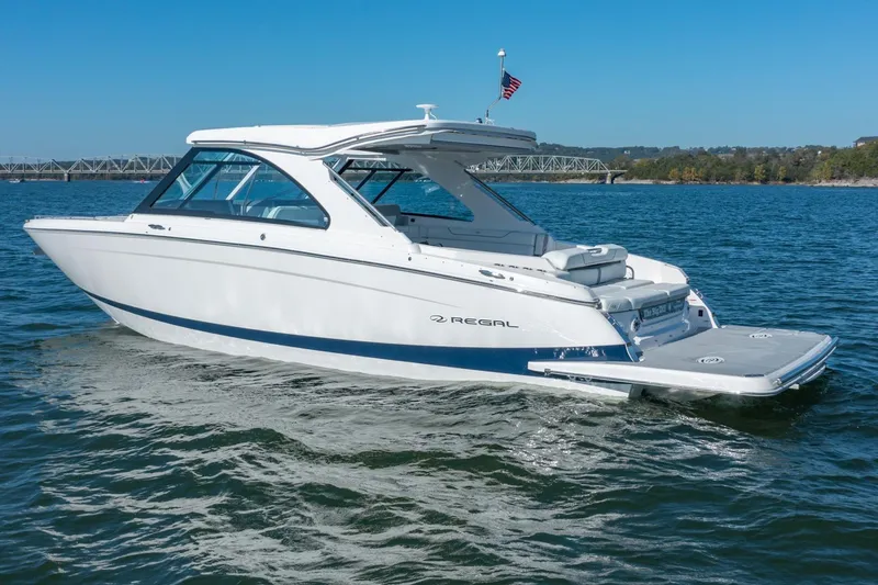 The Big Dill Yacht Photos Pics 2023 Regal LS36 boat cruising on a sunny day, with bridge in background.