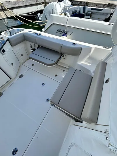  Yacht Photos Pics 2025 Boston Whaler 365 Conquest boat interior with cushioned seating and storage compartments.