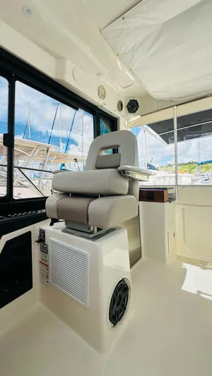  Yacht Photos Pics 2025 Boston Whaler 365 Conquest interior with captain's chair and modern design.