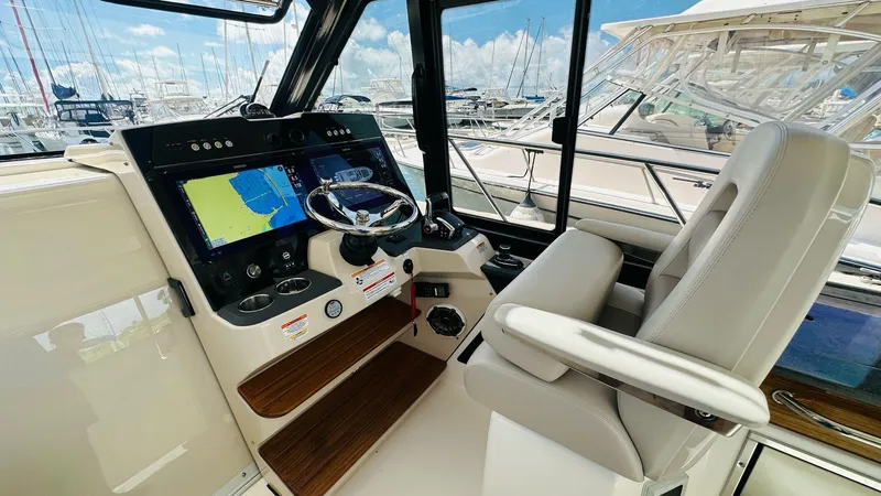  Yacht Photos Pics 2025 Boston Whaler 365 Conquest helm with modern navigation system and comfortable seating.