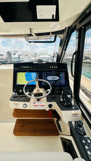  Yacht Photos Pics 2025 Boston Whaler 365 Conquest helm with advanced navigation system and sleek design.