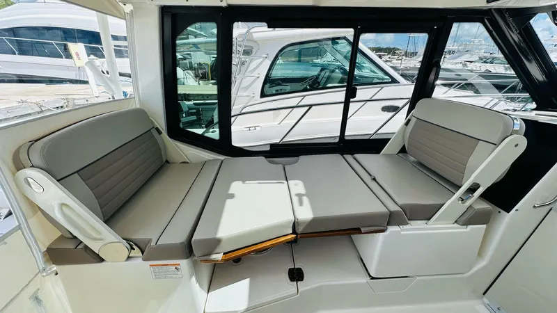  Yacht Photos Pics 2025 Boston Whaler 365 Conquest interior seating area with convertible lounge.