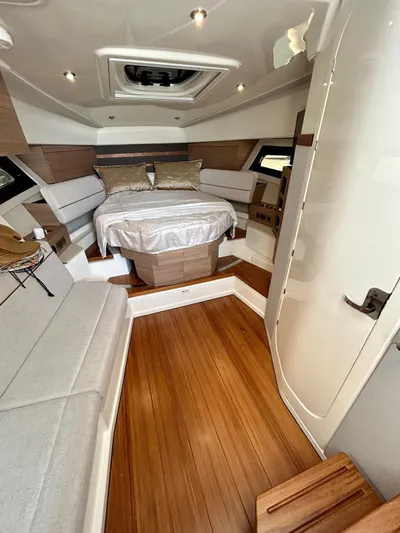  Yacht Photos Pics Luxurious interior of 2025 Boston Whaler 365 Conquest with wood flooring and cozy bed.