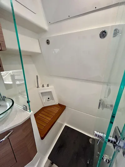  Yacht Photos Pics 2025 Boston Whaler 365 Conquest bathroom with modern fixtures and wooden accents.