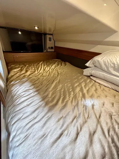  Yacht Photos Pics Cozy cabin interior of 2025 Boston Whaler 365 Conquest with bed and TV.