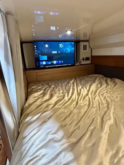  Yacht Photos Pics 2025 Boston Whaler 365 Conquest cabin with bed and wall-mounted TV.