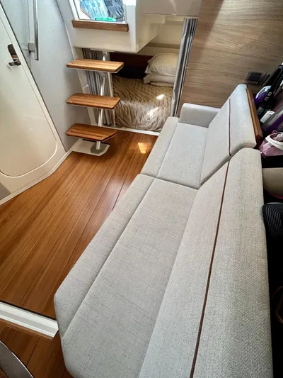  Yacht Photos Pics 2025 Boston Whaler 365 Conquest interior with modern seating and wooden flooring.