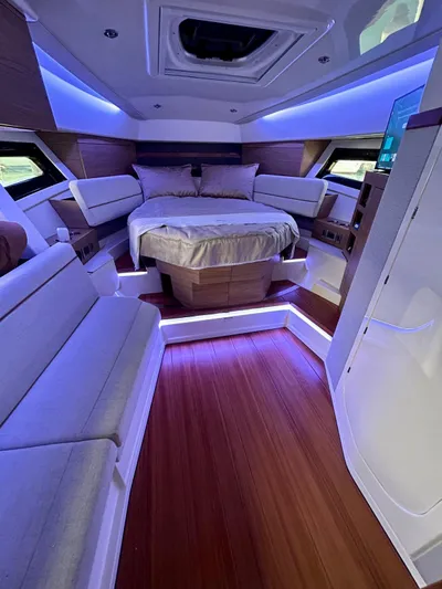  Yacht Photos Pics Luxurious interior of 2025 Boston Whaler 365 Conquest with modern lighting and cozy seating.