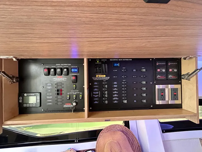  Yacht Photos Pics Electrical control panel inside 2025 Boston Whaler 365 Conquest boat, featuring various switches and displays.