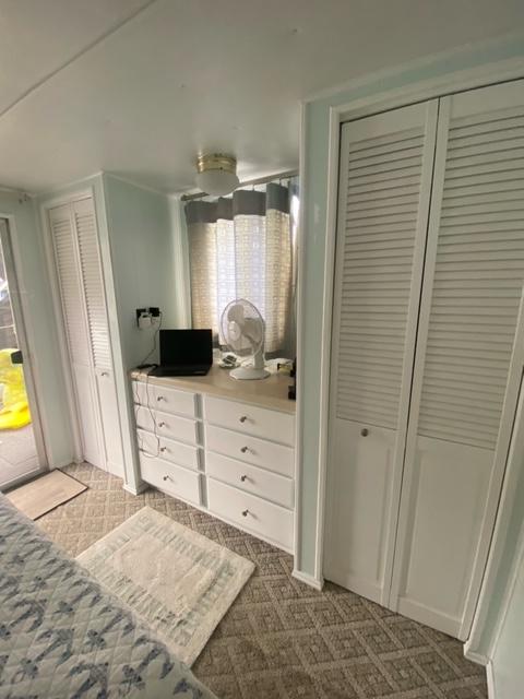 Interior of 1985 Arc houseboat with white cabinets and cozy decor.