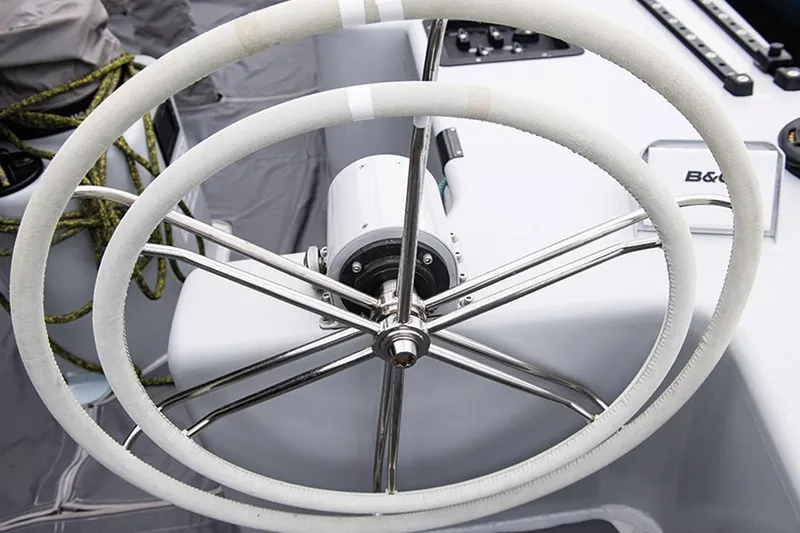 Enterprise Yacht Photos Pics Steering wheel of a 1997 Sparkman & Stephens 12M yacht, featuring dual white wheels.