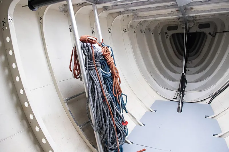 Enterprise Yacht Photos Pics Interior of a 1997 Sparkman & Stephens 12M yacht, featuring ropes and structural details.