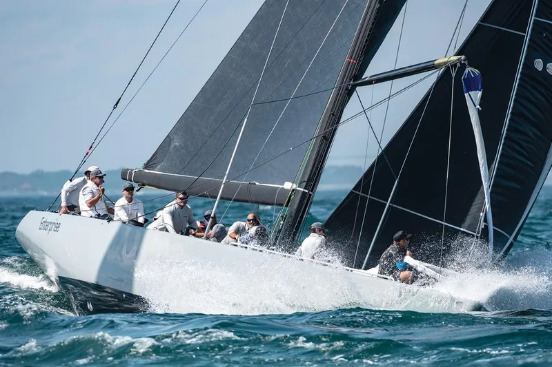 Enterprise Yacht Photos Pics Sailing yacht Sparkman & Stephens 12M, 1997 model, cutting through waves with crew onboard.