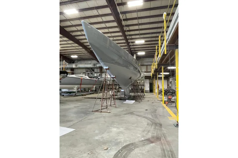 Enterprise Yacht Photos Pics Sailboat in a warehouse, Sparkman & Stephens 12M, 1997 model, under maintenance.