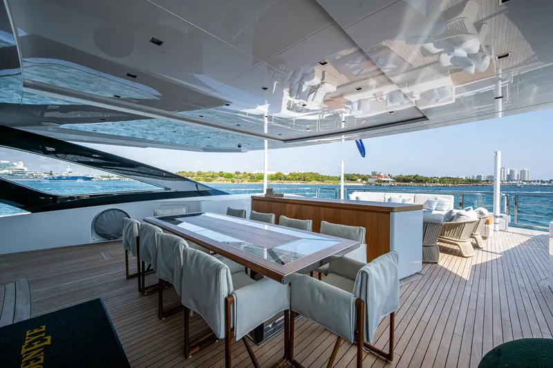 Goldeneye Yacht Photos Pics Luxurious deck of 2020 Mangusta 54 Gransport yacht with elegant seating and ocean view.