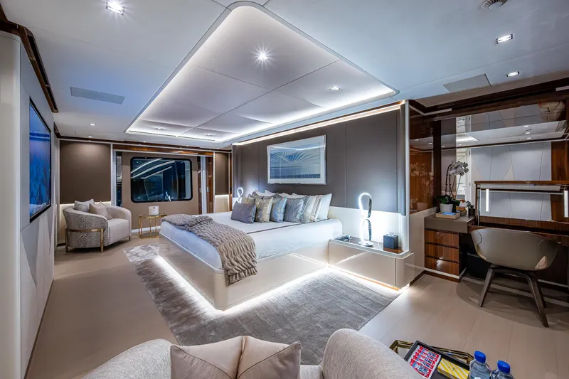 Goldeneye Yacht Photos Pics Luxurious interior of 2020 Mangusta 54 Gransport yacht, featuring modern bedroom design and ambient lighting.