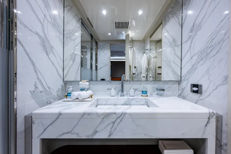 Goldeneye Yacht Photos Pics Luxurious marble bathroom in 2020 Mangusta 54 Gransport yacht, featuring elegant fixtures and modern design.