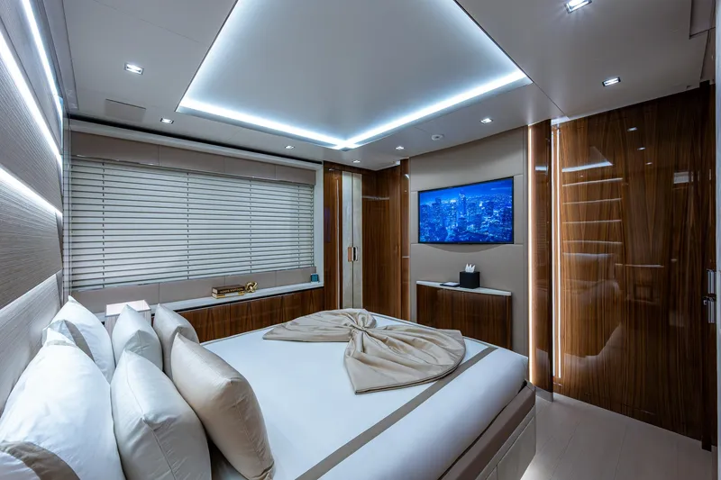 Goldeneye Yacht Photos Pics Luxurious bedroom interior of 2020 Mangusta 54 Gransport yacht with modern design and ambient lighting.